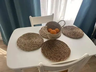 a white table with baskets on a white chair at ruzafa oceanograf science center in Valencia