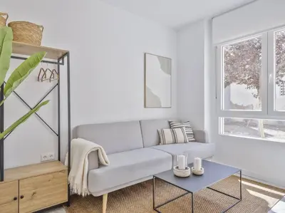 a living room with a couch and a table at Loft Temporal a 2 min de Playa de Sagunto A1 in Puerto de Sagunto