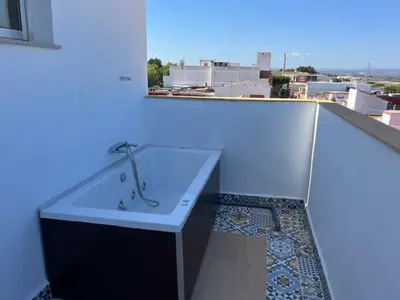 a bathroom with a bath tub on a balcony at ALZIRA BONITA APARTAMENTO CON TERRAZA Y JACUZZi EXTERIOR in Alzira
