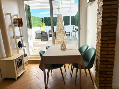 a dining room with a table and chairs and a fireplace at Encantador piso en Benimaclet in Valencia