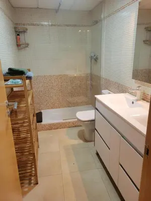 a bathroom with a toilet and a shower and a sink at APARTAMENTO MODERNO y ACOGEDOR in Canet de Berenguer