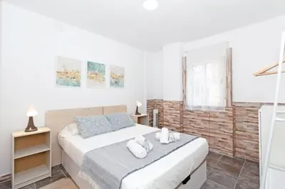 a bedroom with a bed with towels on it at GuestReady - Apartamento en Benicalap in Valencia