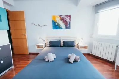 a bedroom with a large blue bed with two pillows at Apt Ruzafa, City Centre 10 Min, Terrace, 2 Rooms in Valencia