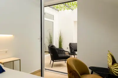 a living room with a sliding glass door leading to a patio at Forata lofts in Valencia