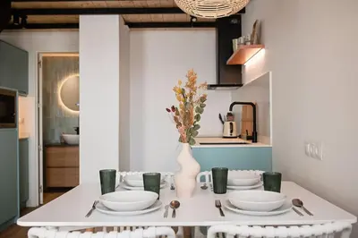 a white table with a vase on it in a kitchen at Lofts plaza JM Orense B in Valencia