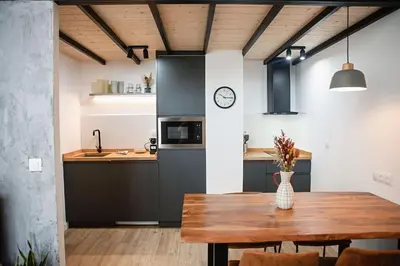 a kitchen with a wooden table and a dining room at Lofts JM Orense D Amplio y cercano a la playa in Valencia