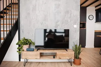 a living room with a tv on a wall at Lofts JM Orense D Amplio y cercano a la playa in Valencia