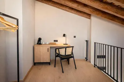 a bedroom with a large white bed and a table at Tradere Hotel Boutique in Moncada
