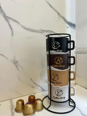 a rack of coffee cups and gold balls on a counter at loft con wifi lavadora secadora cama agradable muy proximo valencia in Benimamet