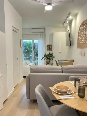 a living room with a couch and a table at loft con wifi lavadora secadora cama agradable muy proximo valencia in Benimamet