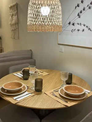 a wooden table with plates and glasses on it at loft con wifi lavadora secadora cama agradable muy proximo valencia in Benimamet
