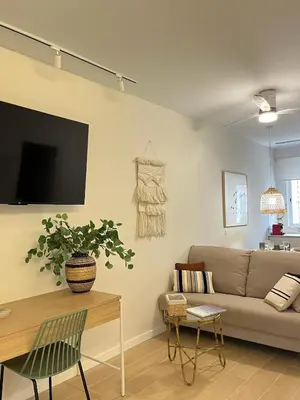 a living room with a couch and a table at loft con wifi lavadora secadora cama agradable muy proximo valencia in Benimamet