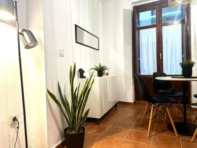 a living room with a table and a plant at Guillem Silence in Valencia