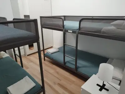 a room with two bunk beds and a chair at Apartamento 4 habitaciones y 2 baños in Puerto de Sagunto