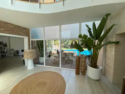 a living room with a potted plant and a table at CASA Silvestre in La Eliana