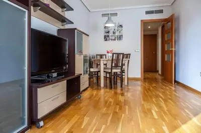 a living room with a television and a table with chairs at Valencia Flat Rental Swim and Paddle in Valencia