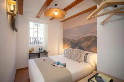 a bedroom with a bed with a painting on the wall at Casual Natura Valencia in Valencia