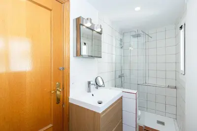 a bathroom with a sink and a mirror at GuestReady - Charming stay in the Heart of Russafa in Valencia