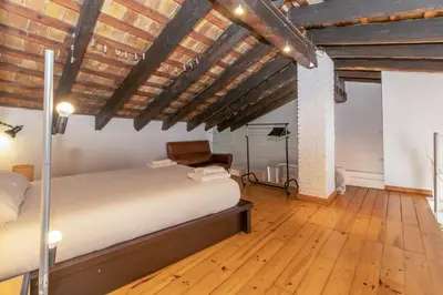 a bedroom with a bed and a wooden floor at GuestReady - Charming stay in the Heart of Russafa in Valencia