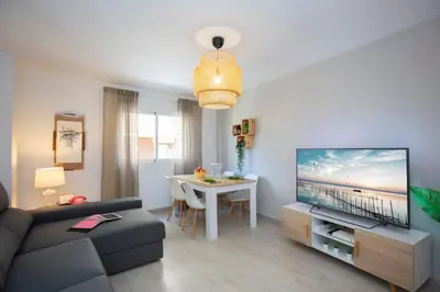a living room with a couch and a tv and a table at GuestReady - A joyful stay in Poblats Marítims in Valencia