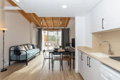a kitchen and living room with a table and a couch at GuestReady - Superb retreat in Ruzafa in Valencia