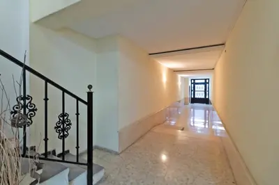 a hallway with white walls and a black railing at GuestReady - A lovely gem near La Malvarrosa beach in Valencia