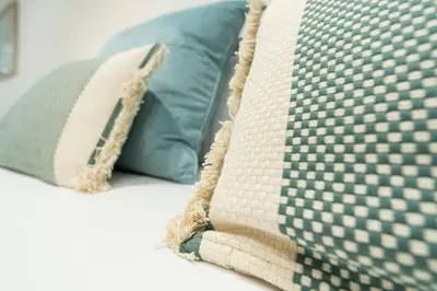 a close up of two pillows on a bed at VLC HOST- Sant Jordi in Valencia