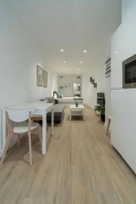 a living room with a table and a couch at VLC HOST- Sant Jordi in Valencia