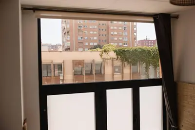 a window with a view of a building at Lofts plaza JM Orense C in Valencia