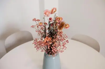 a white vase with a bunch of flowers in it at Lofts plaza JM Orense C in Valencia