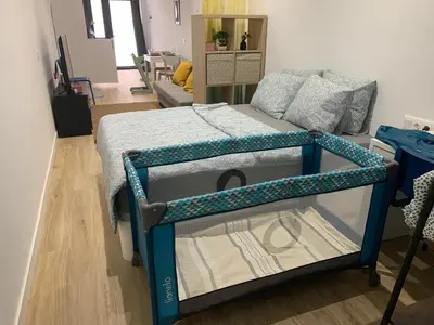 a bed with a blue frame in a room at Quiet room in a park close to the sea & beach & subway No-4 in Valencia