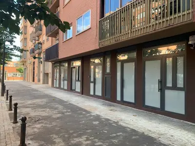 an empty street in front of a brick building at Quiet room in a park close to the sea & beach & subway No-4 in Valencia