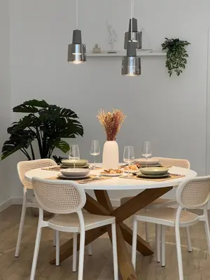 a dining room table with chairs and a white table with wine glasses at Main Lofts Valencia in Valencia