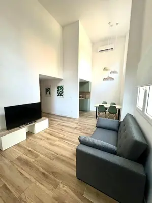 a living room with a couch and a flat screen tv at Gran apartamento a pie de calle in Valencia