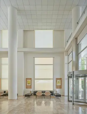 a lobby with chairs and tables in a building at Hotel Santamarta in Cullera