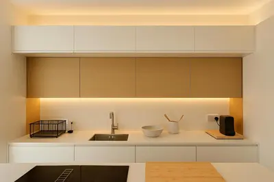 a kitchen with white cabinets and a sink at Design Apartment with swimming pool Ciudad de Ciencias in Valencia