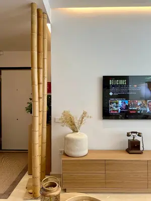 a living room with a tv on the wall at Design Apartment with swimming pool Ciudad de Ciencias in Valencia