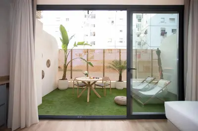a room with a balcony with a table at Nomad Haux Mestalla in Valencia