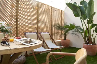 a table and chairs in a room with plants at Nomad Haux Mestalla in Valencia