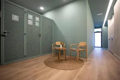 two chairs and a table in a room at Nomad Haux Mestalla in Valencia