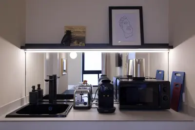 a kitchen with a counter top with a microwave at Osito Hub - Llorens in Valencia