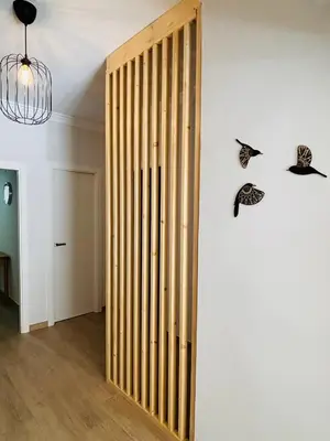 a wooden door in a room with butterflies on the wall at Sun & Sea Cullera in Cullera