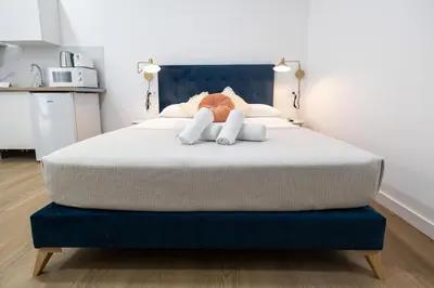 a bedroom with a large bed with two towels at Imprenta Sorolla by Concept in Valencia