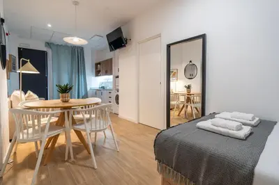 a living room and dining room with a table and chairs at VLC HOST - Ausias March in Valencia
