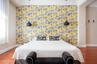 a bedroom with a bed and a yellow wall at Hi Valencia Boutique in Valencia