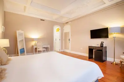 a bedroom with a large white bed and a television at Hi Valencia Boutique in Valencia