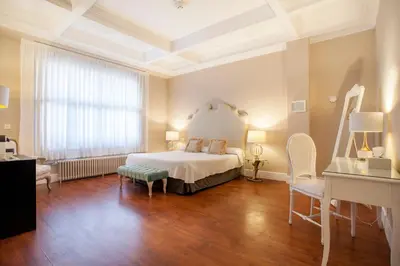 a bedroom with a bed and a table and chairs at Hi Valencia Boutique in Valencia