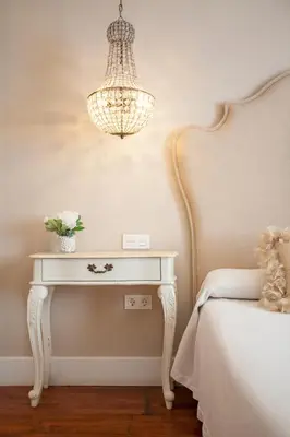 a bedroom with a white table and a chandelier at Hi Valencia Boutique in Valencia