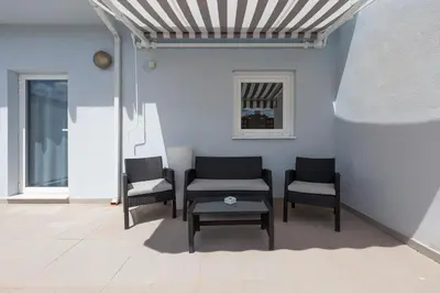 a living room with chairs and a table and a wall at Hotel Olympia Universidades in Valencia