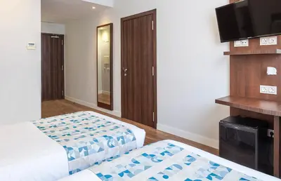a hotel room with two beds and a flat screen tv at Hotel Olympia Universidades in Valencia